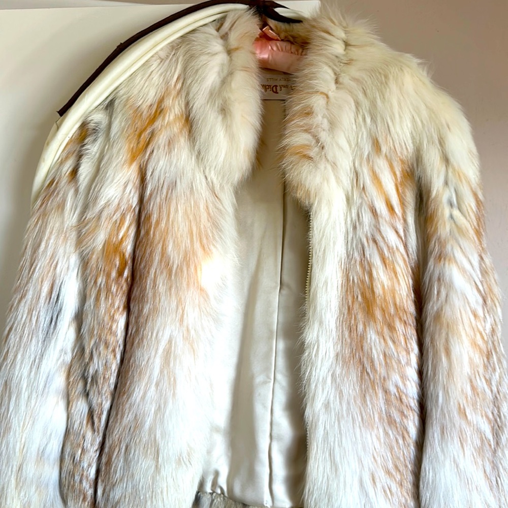 Cream colored fur coat.